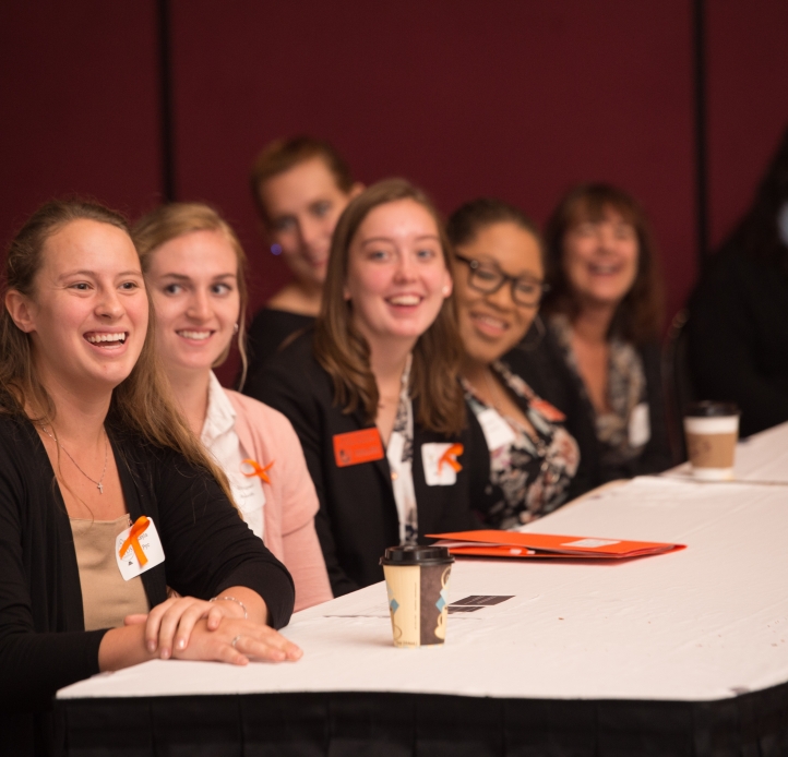 several women presenting from a table