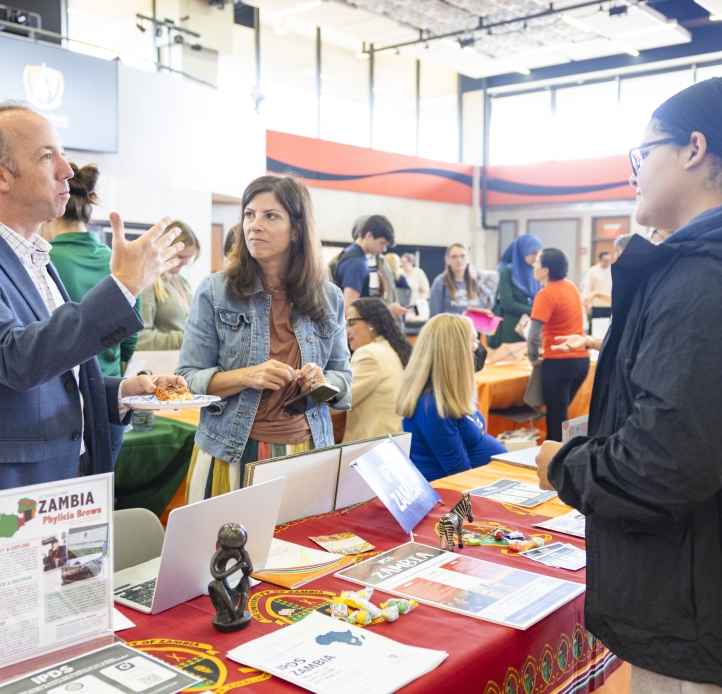 people standing by information table