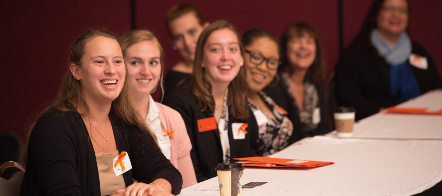 students at a table presenting