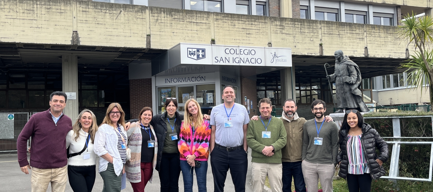 group of adults standing in a row in front of building