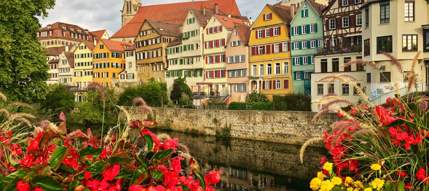 city of Tubingen, Germany with flowers in the forefront and colorful buildings in the back